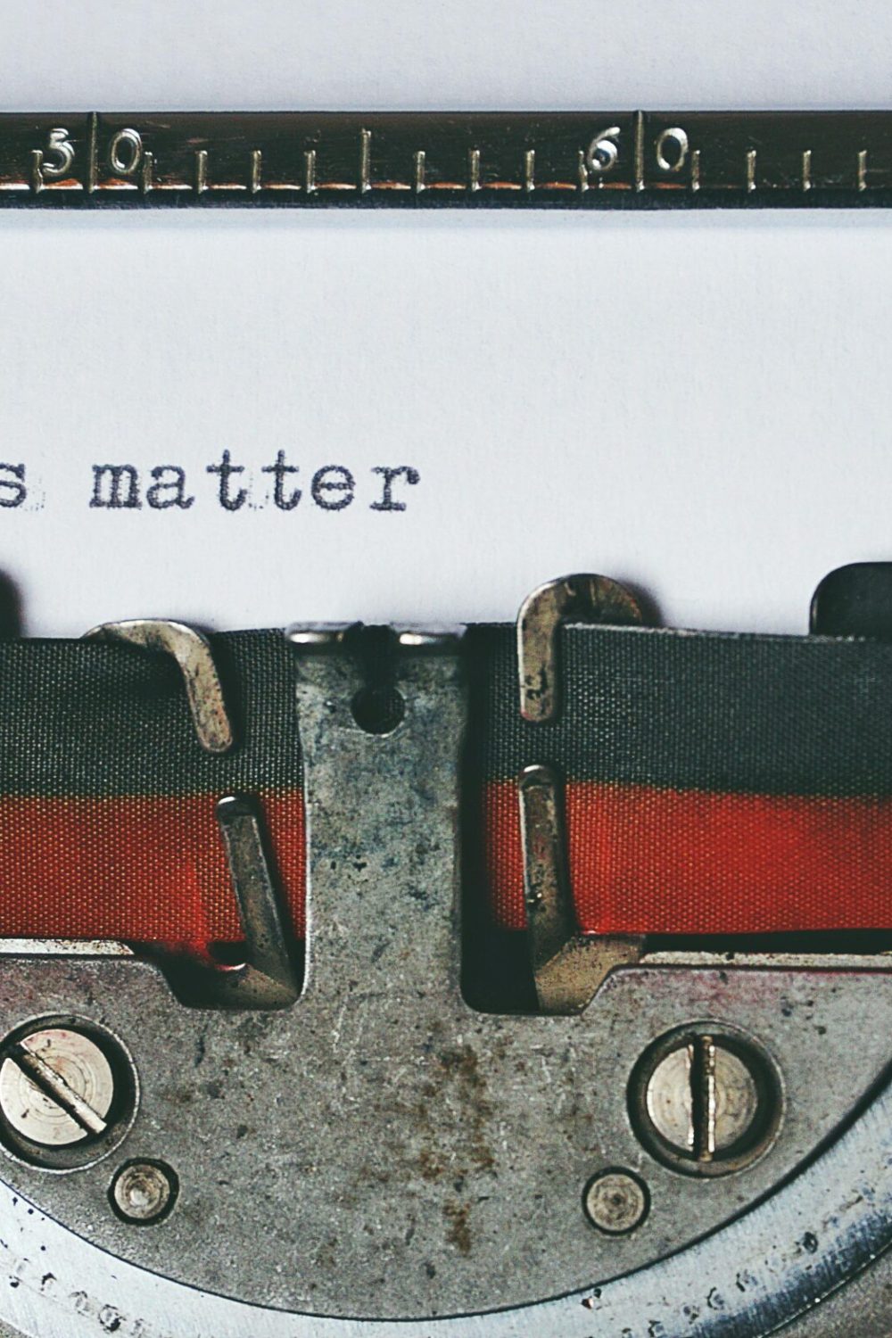 Close-up of a vintage typewriter with the text 'Stories matter' typed on paper, evoking nostalgia.